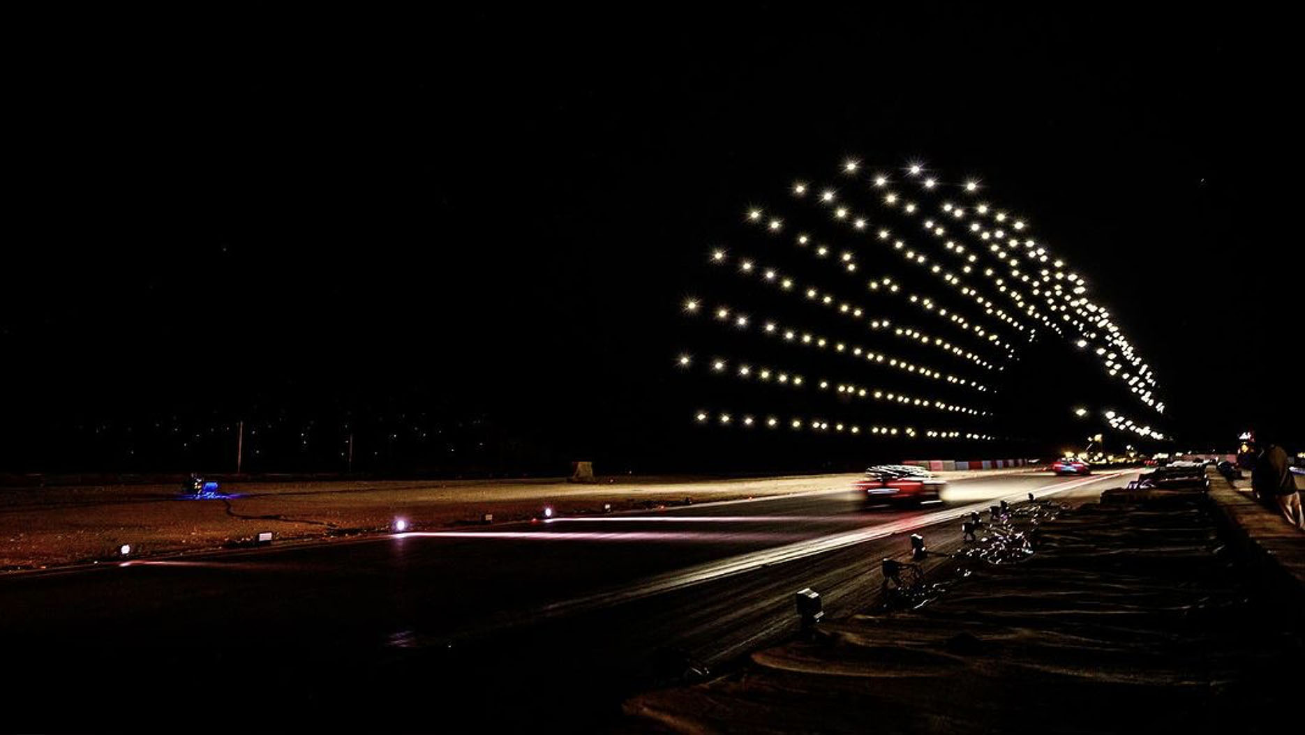 A brightly-lit tunnel in the sky composed by drones during a Nova Sky Stories drone light show.